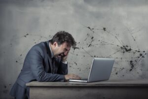 ixbtmedia_A_sad_and_depressed_officeting_his_head_on_fa23a41f-a586-4b57-bc44-3fb48a6a3626_large